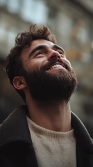 Fototapeta premium Smiling Man Looking Upwards in Urban Setting