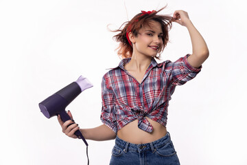 A young woman joyfully having fun while playfully using a hair dryer at home or in a salon