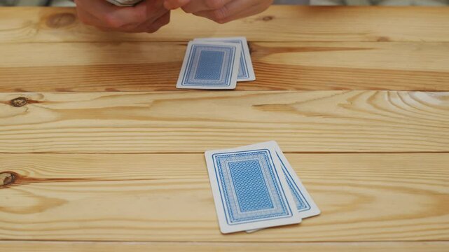 hands deal playing cards before the game. gambling. A board game for spending leisure time with friends and family.