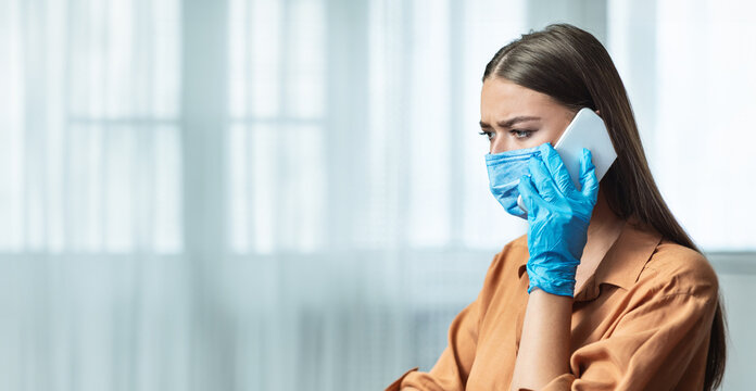 Portrait of worried girl wearing fsce mask and protective gloves working at home and making phone call, free space