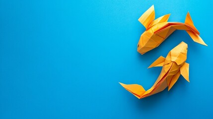 Obraz premium Elegant Origami Goldfish on Vibrant Blue Background