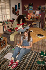 Two teenagers engaging in activities at cozy bedroom with posters and retro study materials. One...