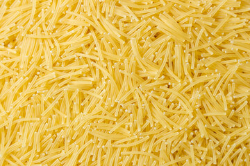 Uncooked Filini Pasta: A Culinary Canvas of Noodles, Creating a Lively and Textured Background for Gourmet Cooking. Dry Pasta. Raw Macaroni - Top View, Flat Lay