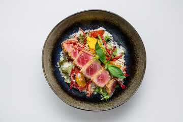 Seared tuna salad with fresh vegetables, citrus slices and parmesan. Gourmet and healthy meal option