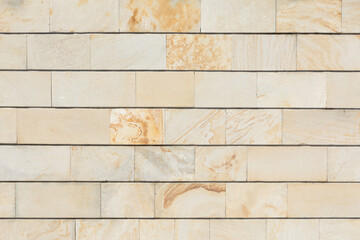 Yellow marble brick wall background. Horizontally.