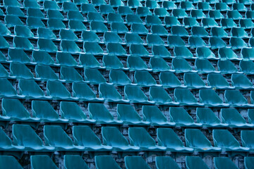Blue seats of tribune on sport stadium empty outdoor arena concept of fans chairs for audience cultural environment concept color empty seats modern stadium.