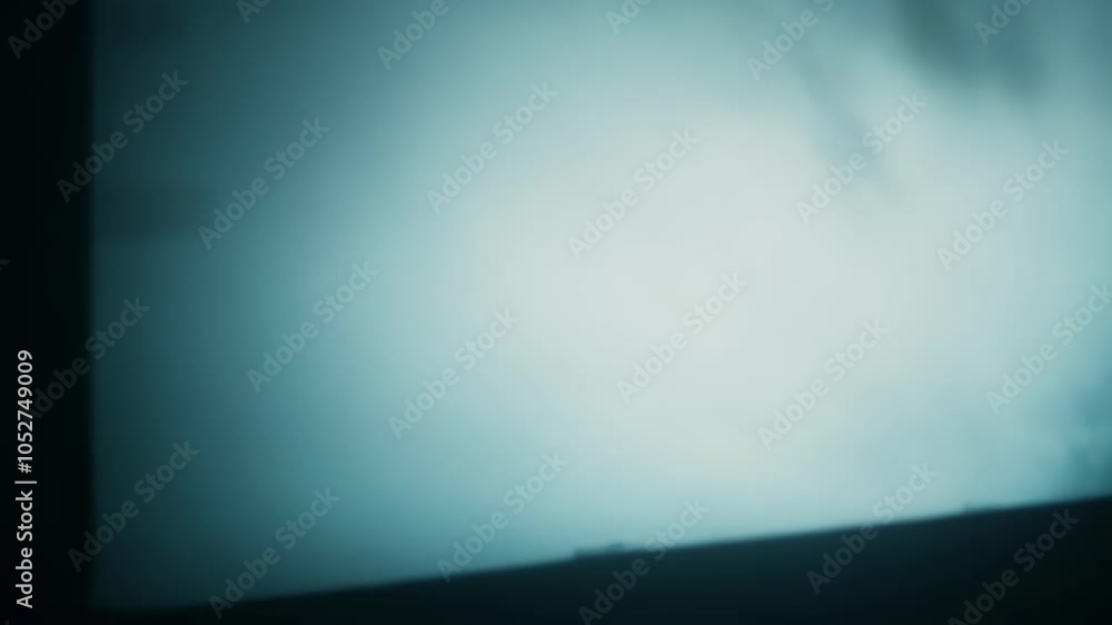 Poster Surreal sequence of a cloudy sky with three dark rectangular objects traversing through it, creating a sense of mystery and movement