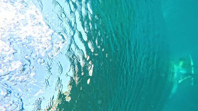 Surfing wave in Bali island. Ocean wave clear water. Uluwatu famous surf destination in Indonesia. Adventure travel. Slow motion.