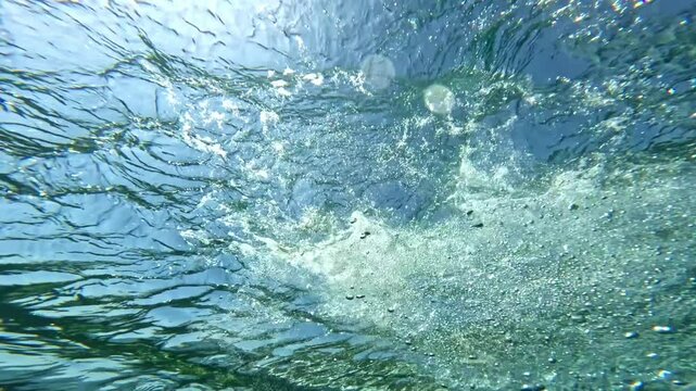 Surfing wave in Bali island. Ocean wave clear water. Uluwatu famous surf destination in Indonesia. Adventure travel. Slow motion.