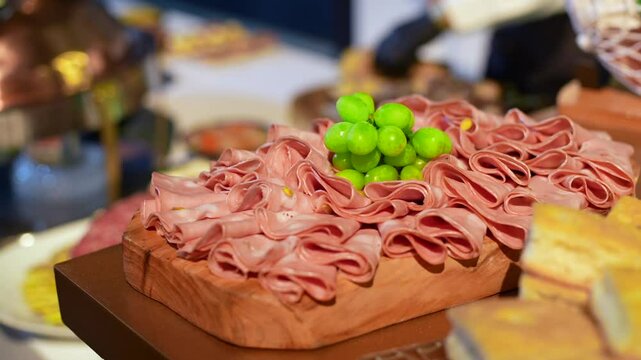 mortadella on a wooden board at an appetizer station at a wedding party