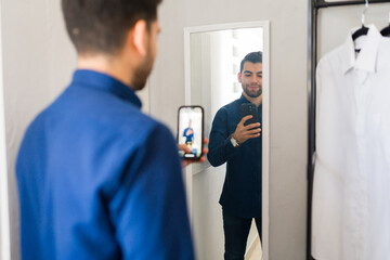 Shopper takes a selfie in the dressing room of a retail store while deciding on a purchase