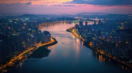 Fototapeta premium An aerial view of the Han River in Seoul, featuring sparkling city lights and reflections