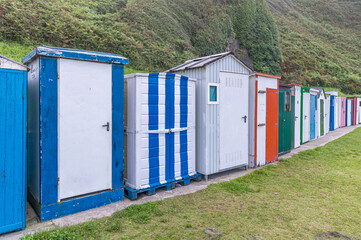 Naklejka premium Colorful huts on a beach in Luarca, Spain