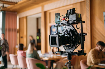 Professional film and video camera on the set. Shooting shift, equipment and group.