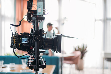 Professional film and video camera on the set. Shooting shift, equipment and group.