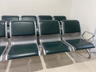 A row of green and silver waiting room chairs