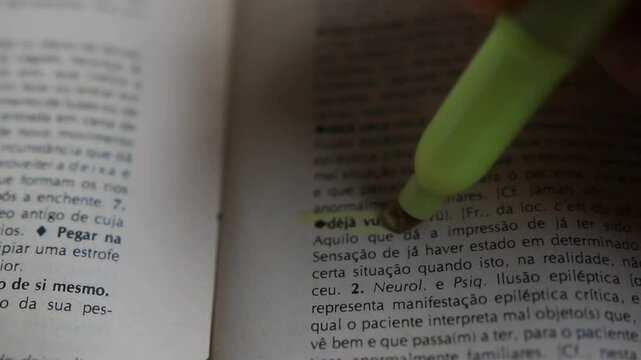 A man marks the words Deja Vu definition on a printed page with a marker pen