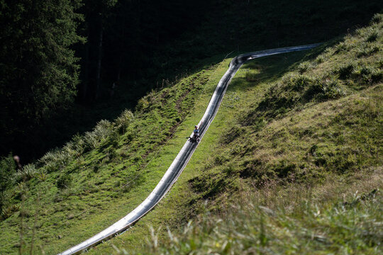 Sledding down a scenic mountain track in Pilatus, Switzerland