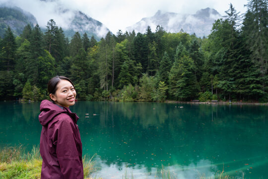 Young asian woman enjoying the scenic beauty at Blausee, Switzerland