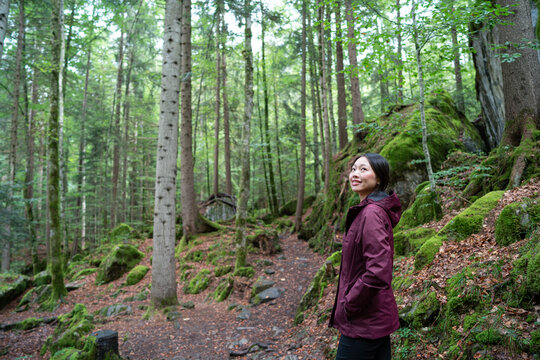 Asian Woman enjoying a serene walk in Naturpark Blausee, Switzerland
