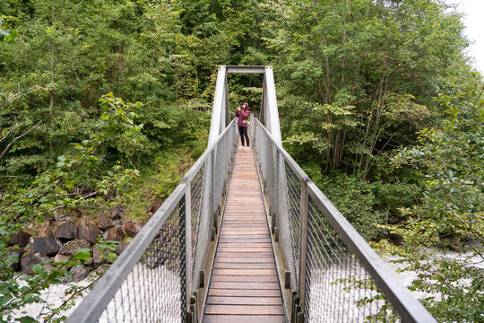 Person walking on a suspension bridge in Blausee Park, Switzerland