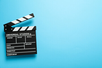 Clapperboard on blue background, space for text
