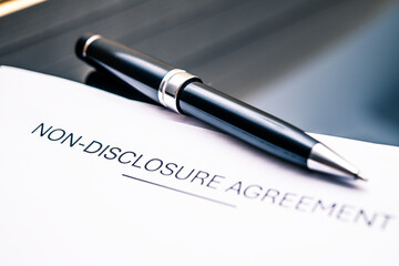 Close-Up of Non-Disclosure Agreement with Elegant Pen on Table, Highlighting Importance of...