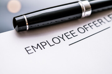 Close-up of a Business Employee Offer Letter and Elegant Pen on a Desk, Signifying Job Opportunities and Professional Employment Contracts