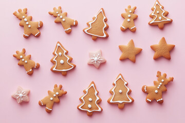 Ginger cookies on pink background with icing and sprinkles, displayed beautifully, tempting and festive.