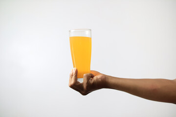 orange juice held by asian hand