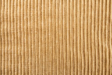 Macro beige corduroy fabric background with slight wear