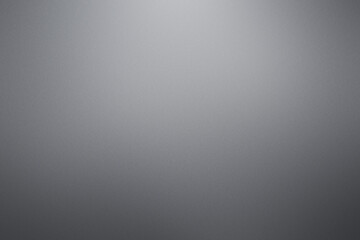 A grey background with no visible objects. Noisy backdrop with grain