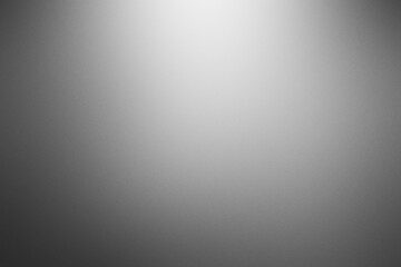 A grey background with a white light shining on it. Noisy backdrop with grain