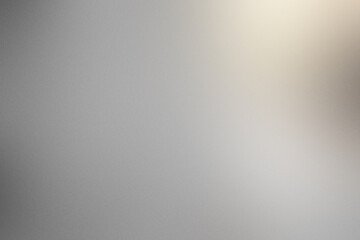 A blurry gray background with a white spot in the middle. Noisy backdrop with grain