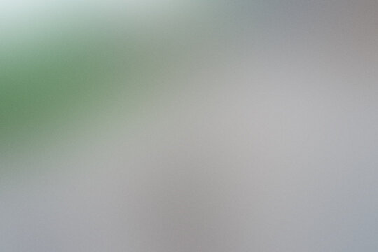 A blurry image of a green and gray background with a white line. Noisy backdrop with grain