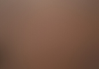 A brown background with a few specks of white. Noisy backdrop with grain