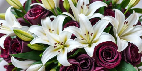 Obraz premium A close-up shot of a beautiful arrangement of funeral flowers with white lilies, dark roses, and green leaves, arrangement, dark roses