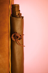 leather pieces set and leather cord on a pink light background.Durable material for making...