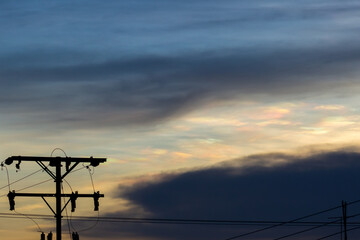 Silhouette of electric pole with twilight sky background