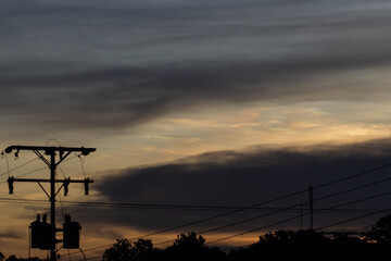 Silhouette of electric pole with twilight sky background