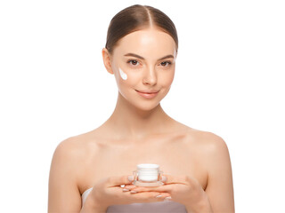 Portrait of young woman applying face cream from jar after shower