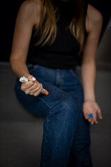 Woman with anaphylaxis or having a severe allergic reaction uses an epinephrine or adrenaline auto-injector epipen. Young girl with allergy. © Christian