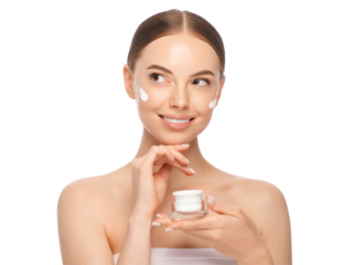 Young woman applying face cream from jar
