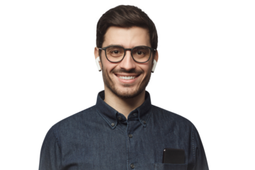 Portrait of young smiling man listeting to his favorite music track with earphones, wearing blue denim shirt and glasses
