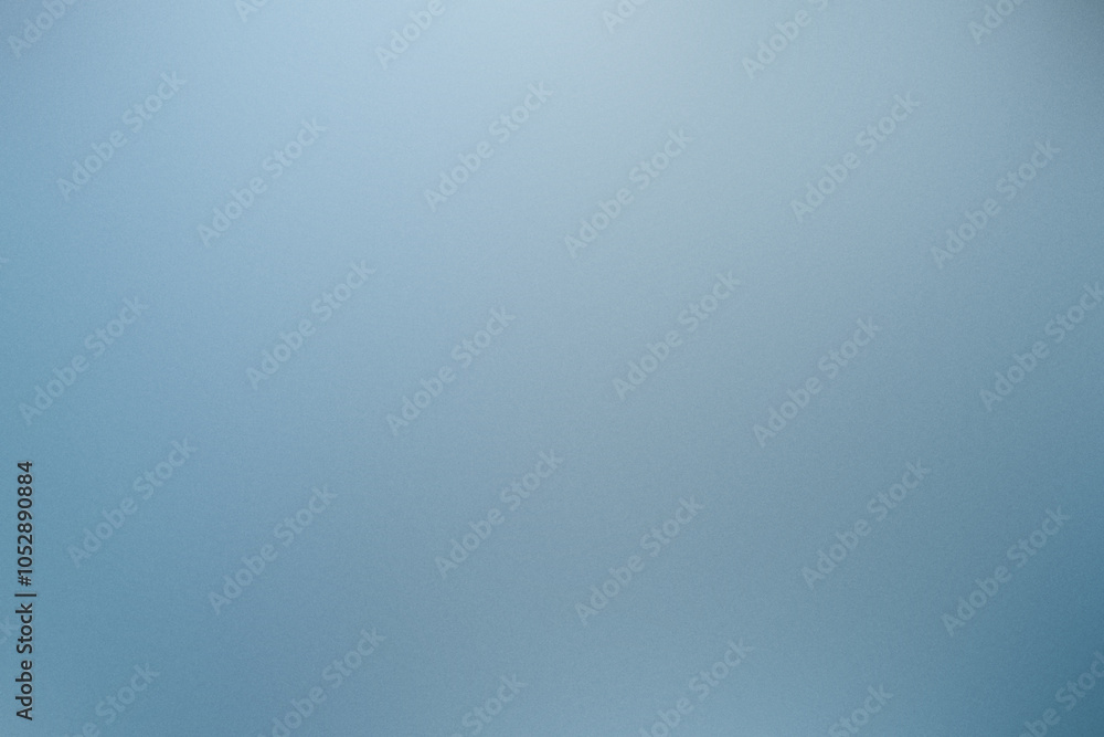 Poster grainy abstract background with a smooth gradient transitioning from light to dark blue tones