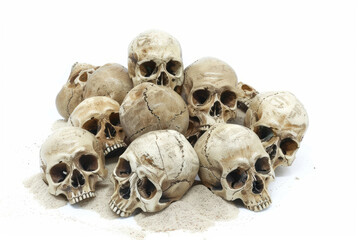 A pile of skulls on the beach with no shadows on a white background in a PNG format.