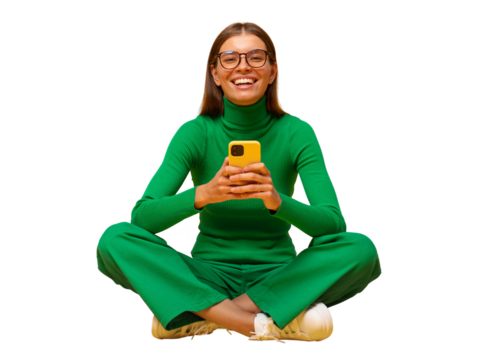 Laughing woman sitting on floor browsing social media posts on phone