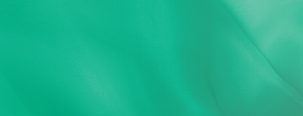 A green background with a smooth, flowing texture. The background features a vibrant green color, creating a calming and serene atmosphere. Minimal abstract flow line vector gradient background