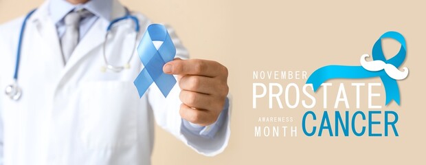 Doctor with blue ribbon on beige background, closeup. Prostate Cancer Awareness Month