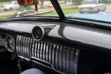 Dashboard of an old car from the 1950s driving on a street in Havana. Cuba.